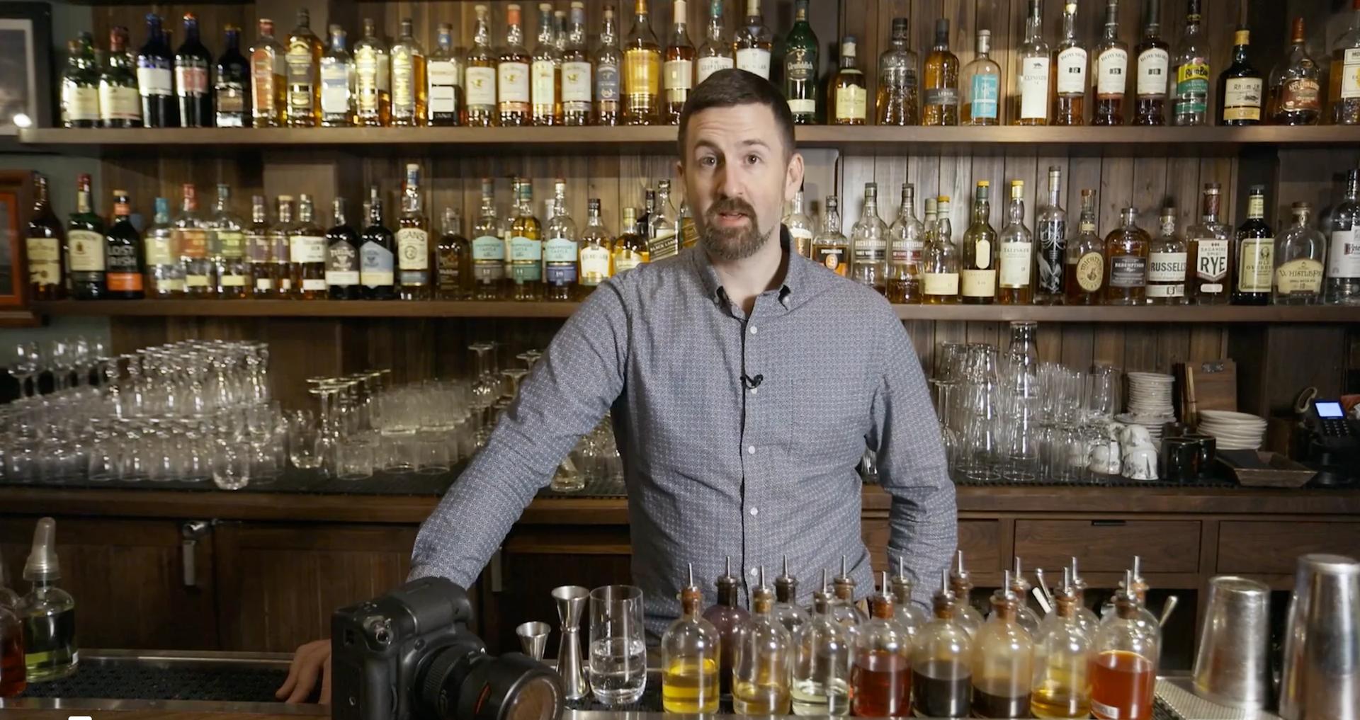 Brent Herrig photographing cocktails behind a bar on a commercial shoot