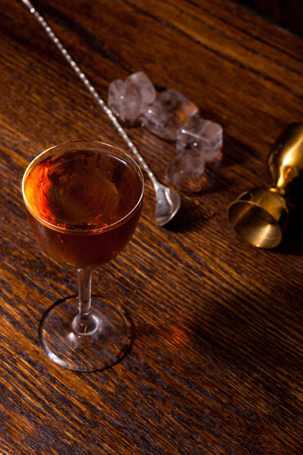 Dead Rabbit NYC whiskey cocktail serve with fresh garnish on speakeasy bar top - brand photography
