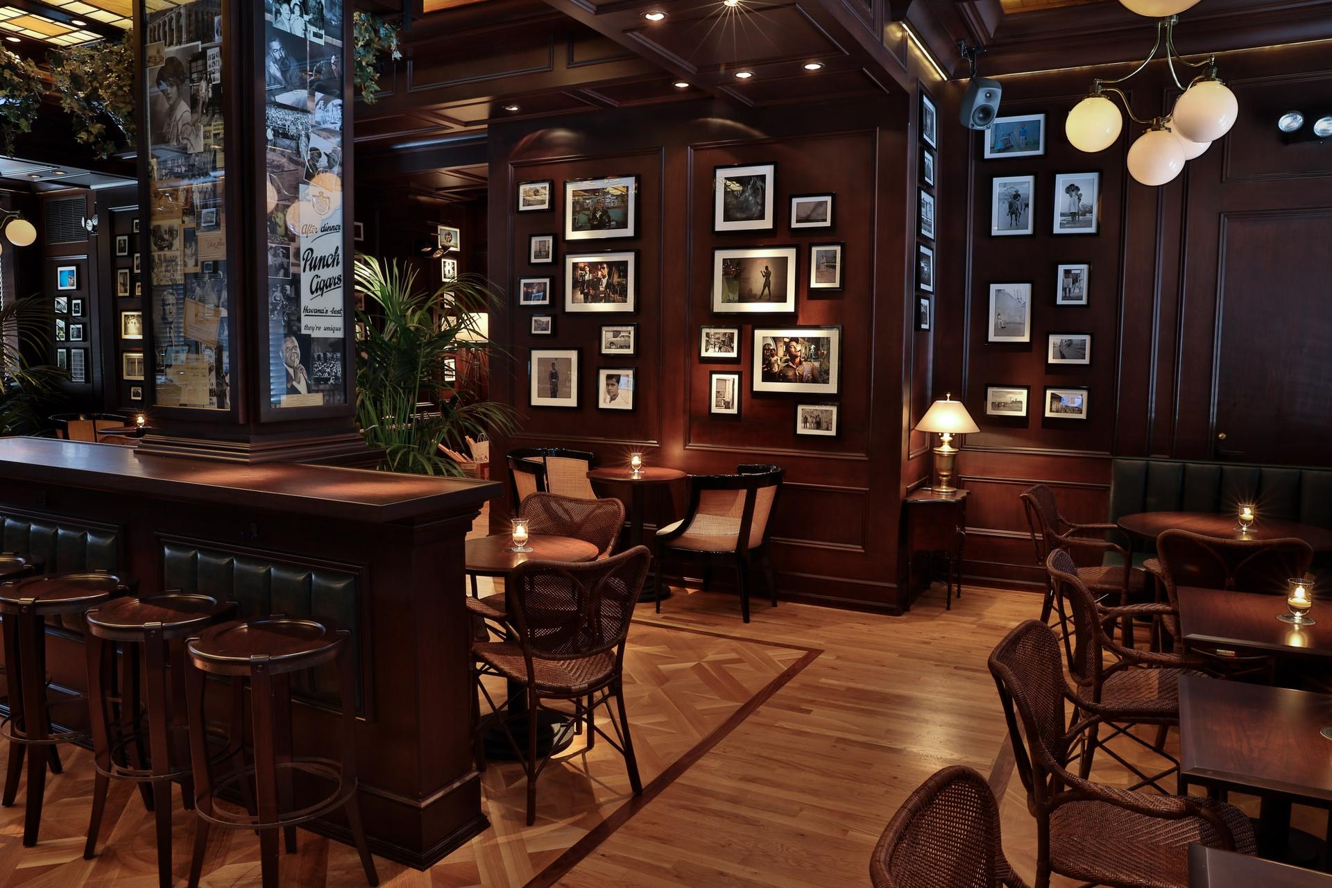 The Blacktail bar interior in New York lit by its own warm practical fixtures as the visible key light
