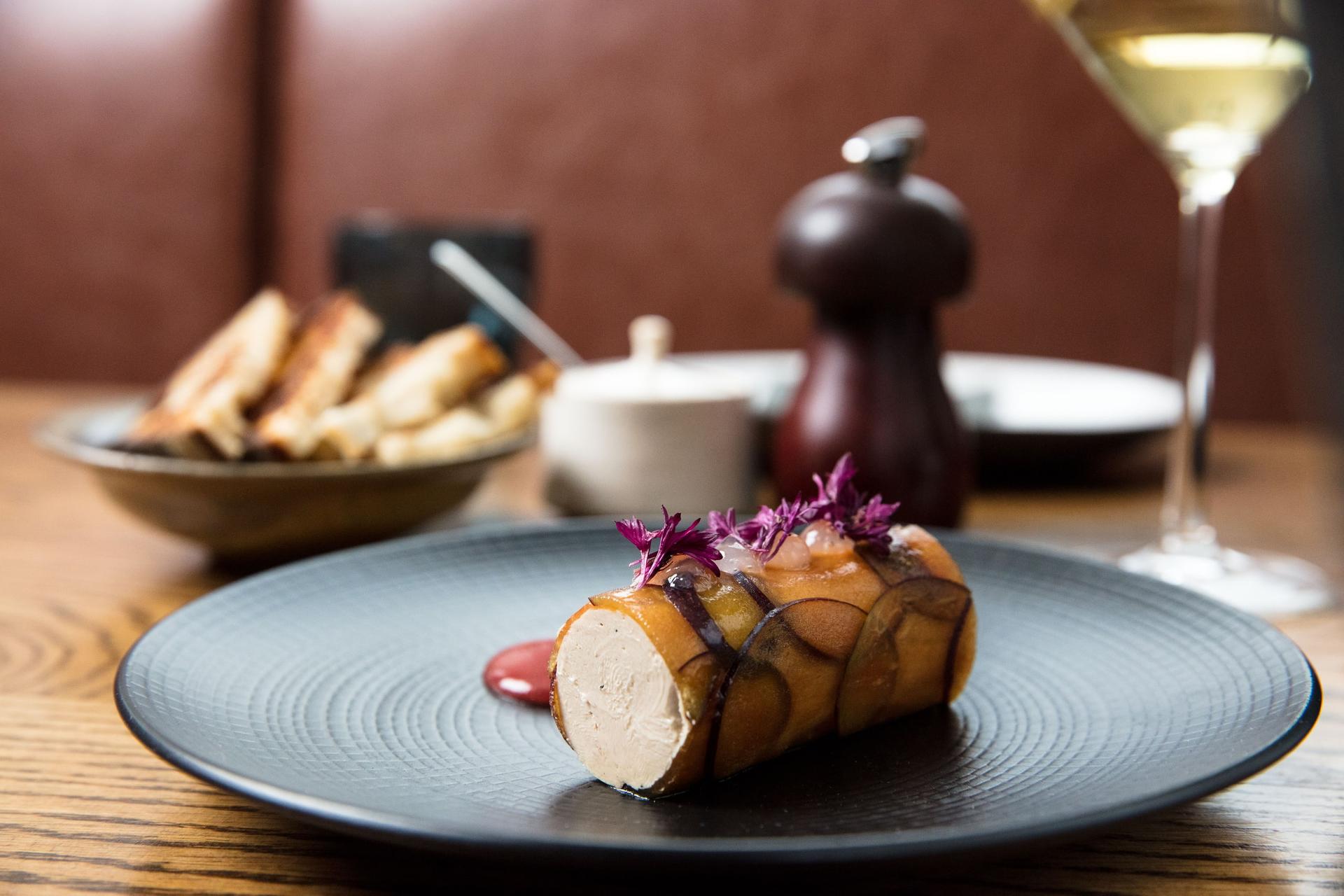 Chef plating at the pass in an open New York restaurant kitchen