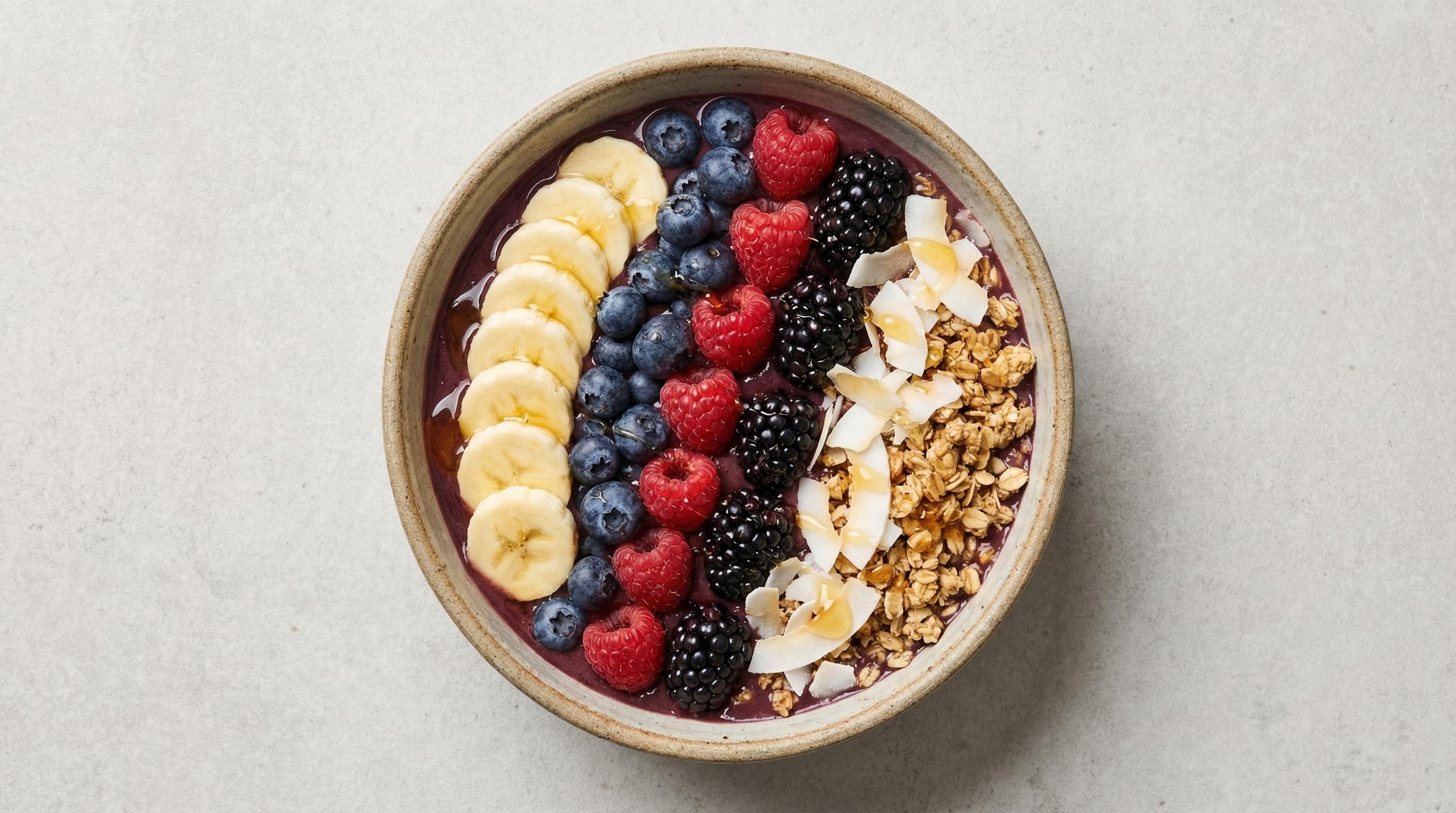 Acai smoothie bowl with arranged fruit and granola toppings, photographed from overhead by Brent Herrig