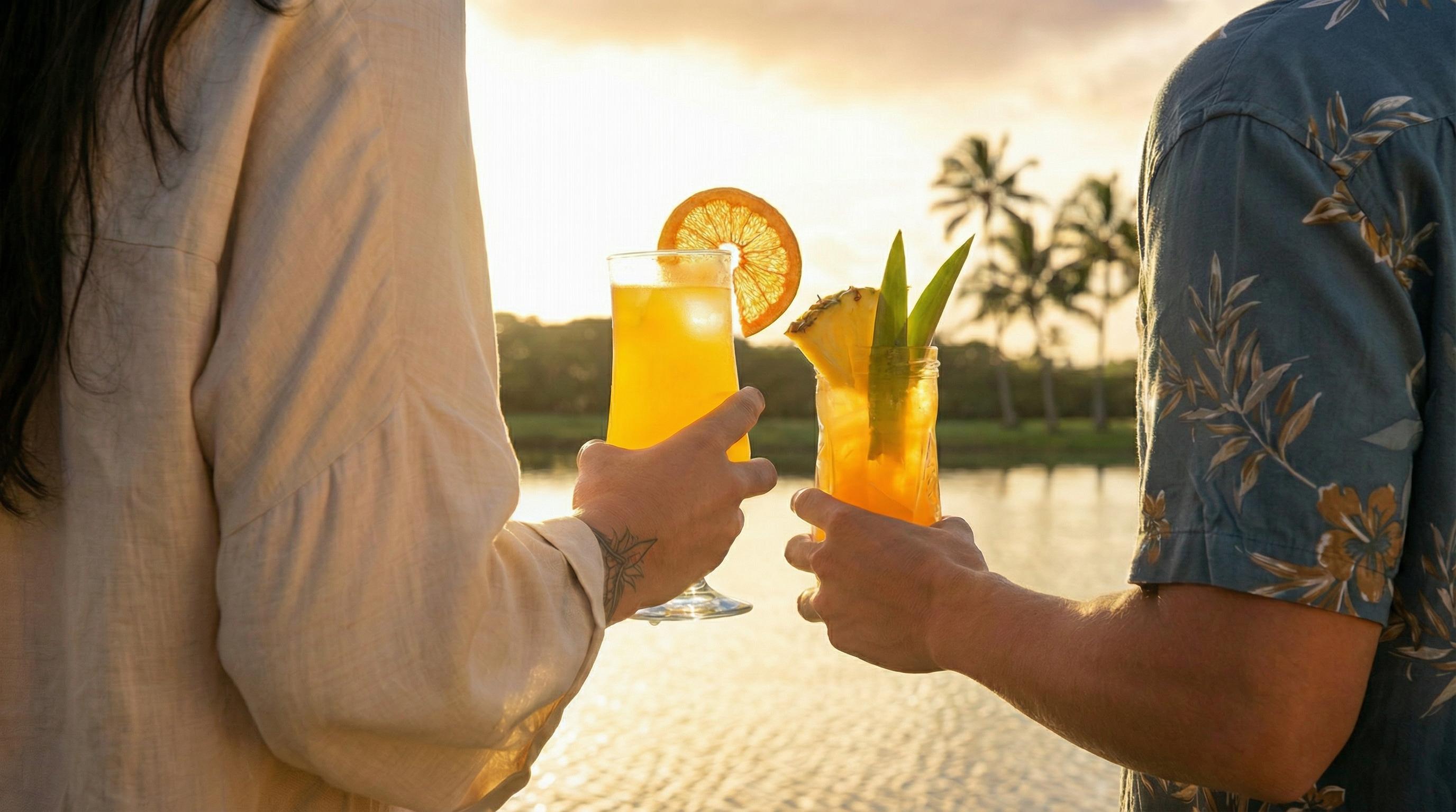 Original cocktail photograph before AI frame extension, showing two tropical drinks at sunset in Hawaii