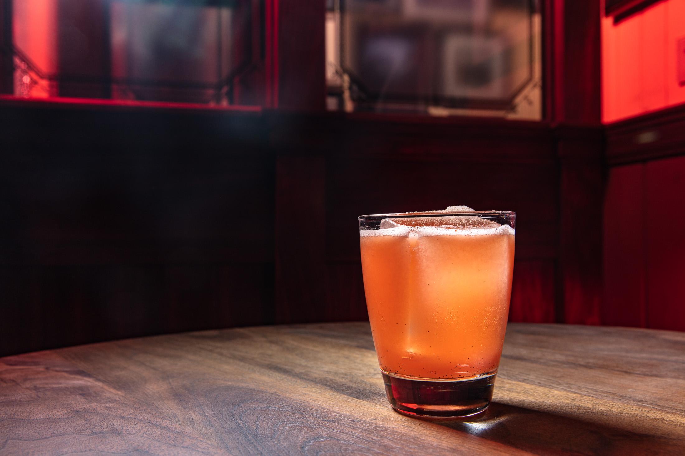 Macro photography of citrus garnish falling into a drink