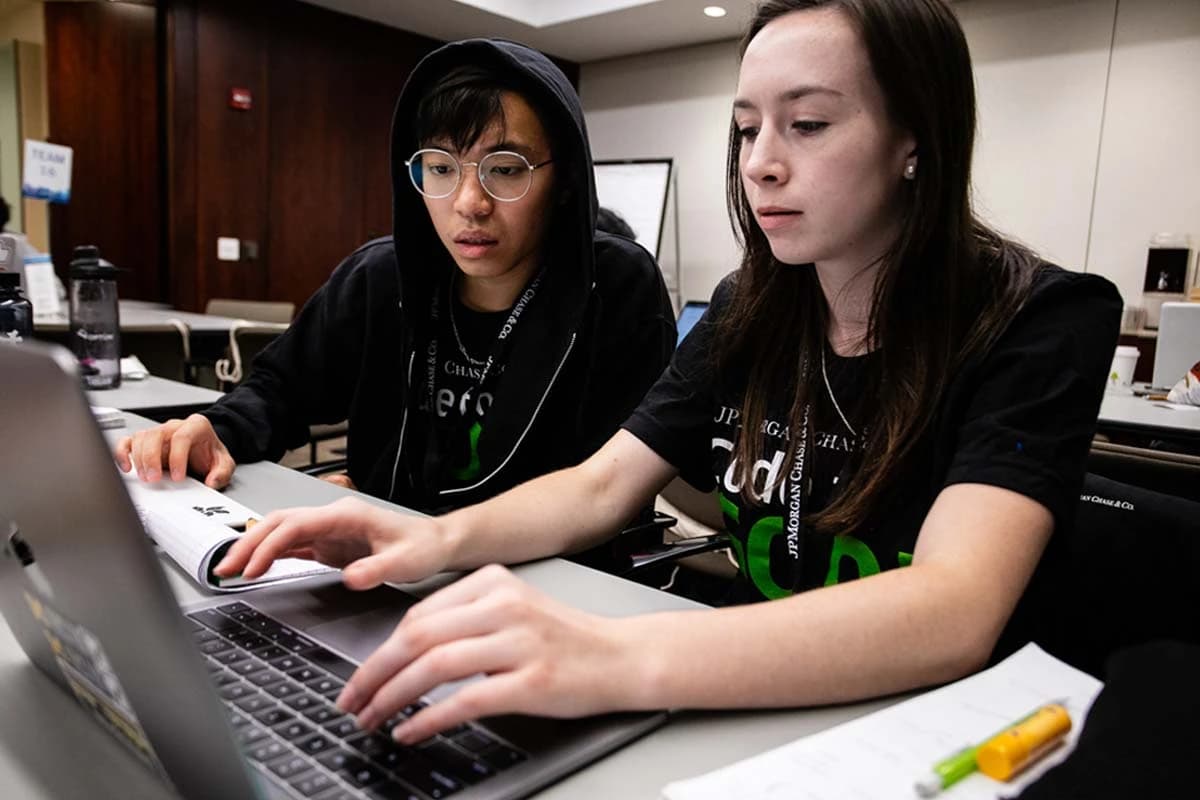 Hackathon event photography showing developers coding