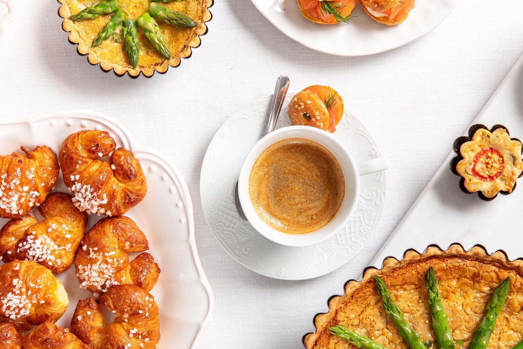 Lavish family-style breakfast spread at Acquolina restaurant featuring pastries and fruit