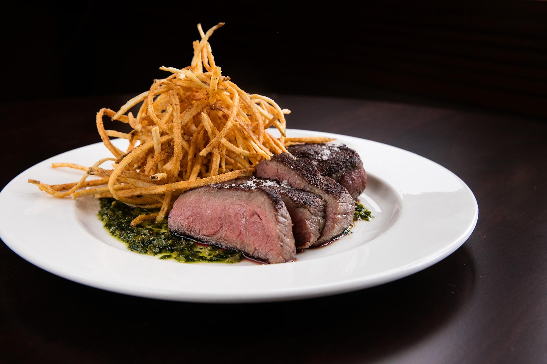 Gourmet bar food appetizer with dramatic lighting at BlackTail NYC