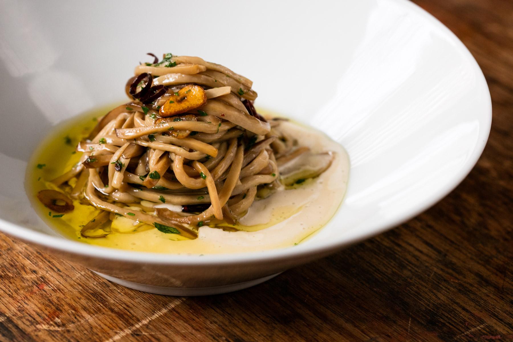 Exotic mushrooms cooking on gas burner