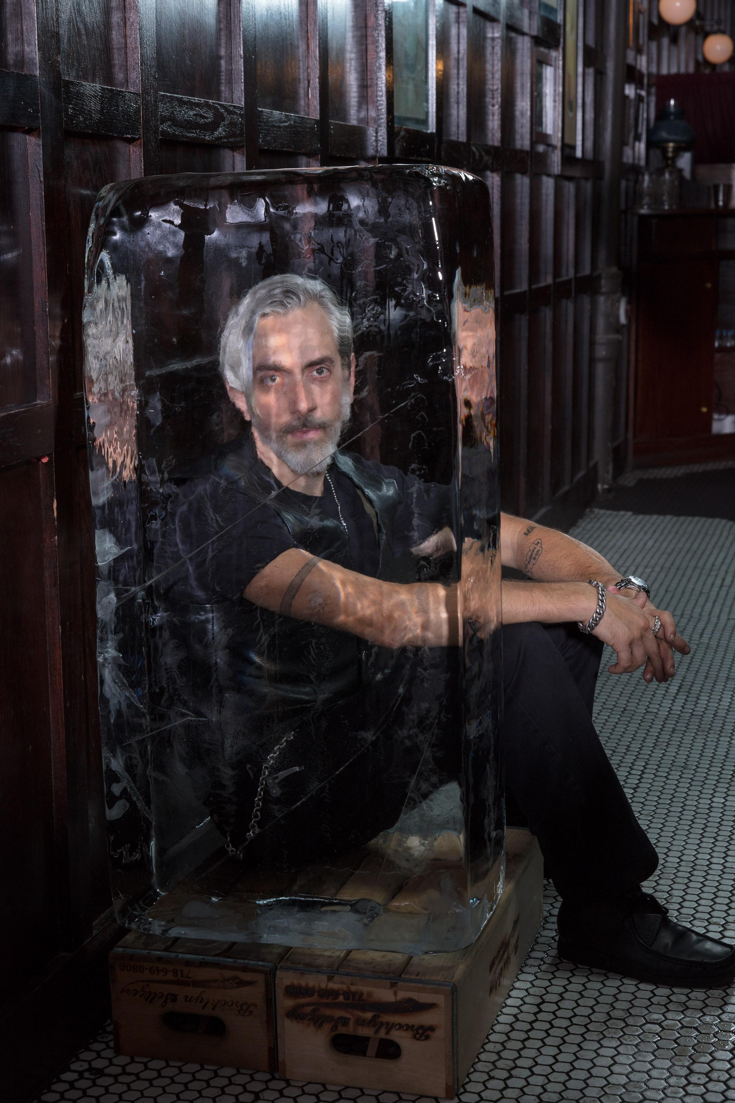 Ice sculptor working with chainsaw in studio