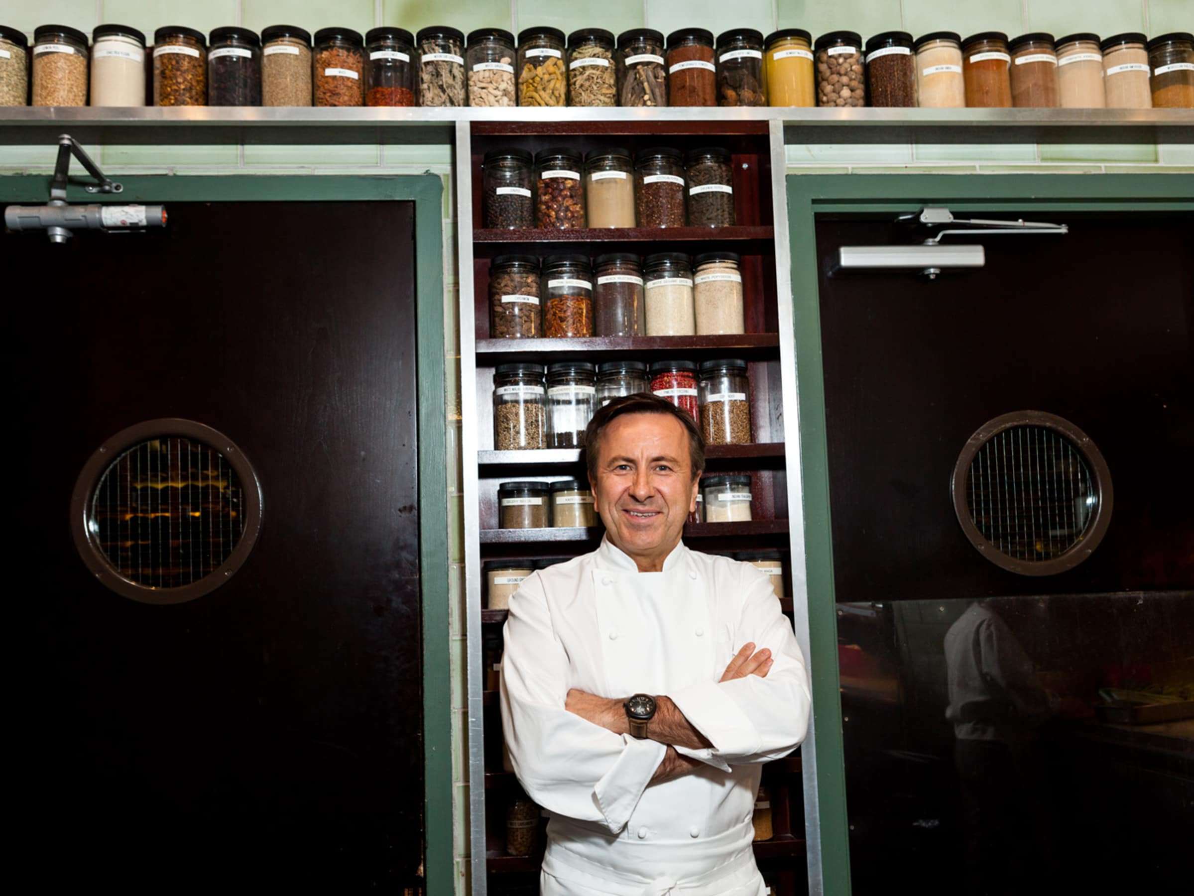 Chef Daniel Boulud smiling in professional kitchen