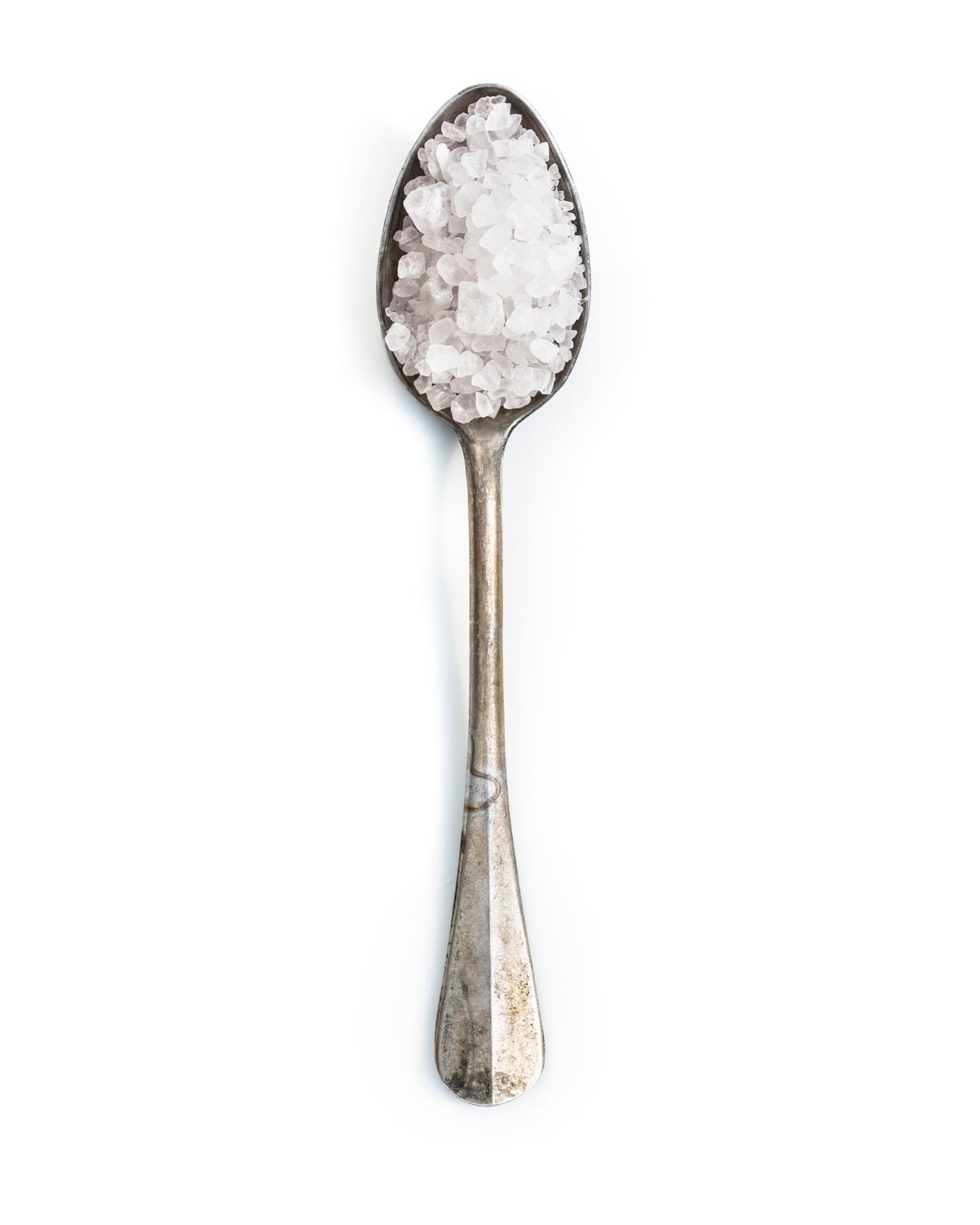 Spoonful portrait of Grandma Sadie Herrig featuring pure sea salt in a small, hollow aluminum heirloom spoon.