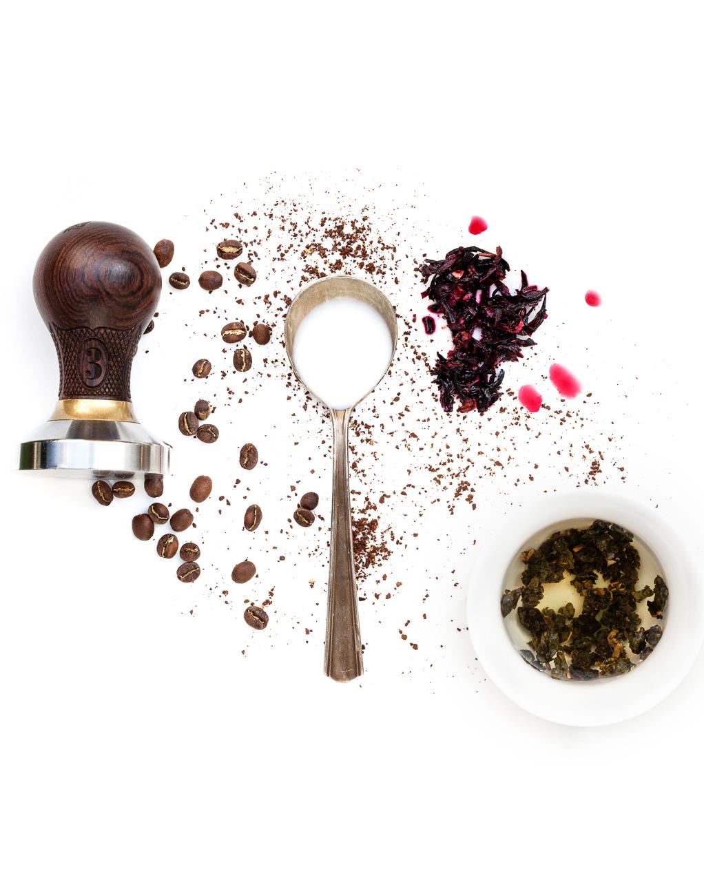 Spoonful portrait of Dale Donchey titled The Last Link, featuring whole bean coffee, ground coffee, tea leaves, hibiscus flower, cream, and water alongside a 1920s silver plated cupping spoon.