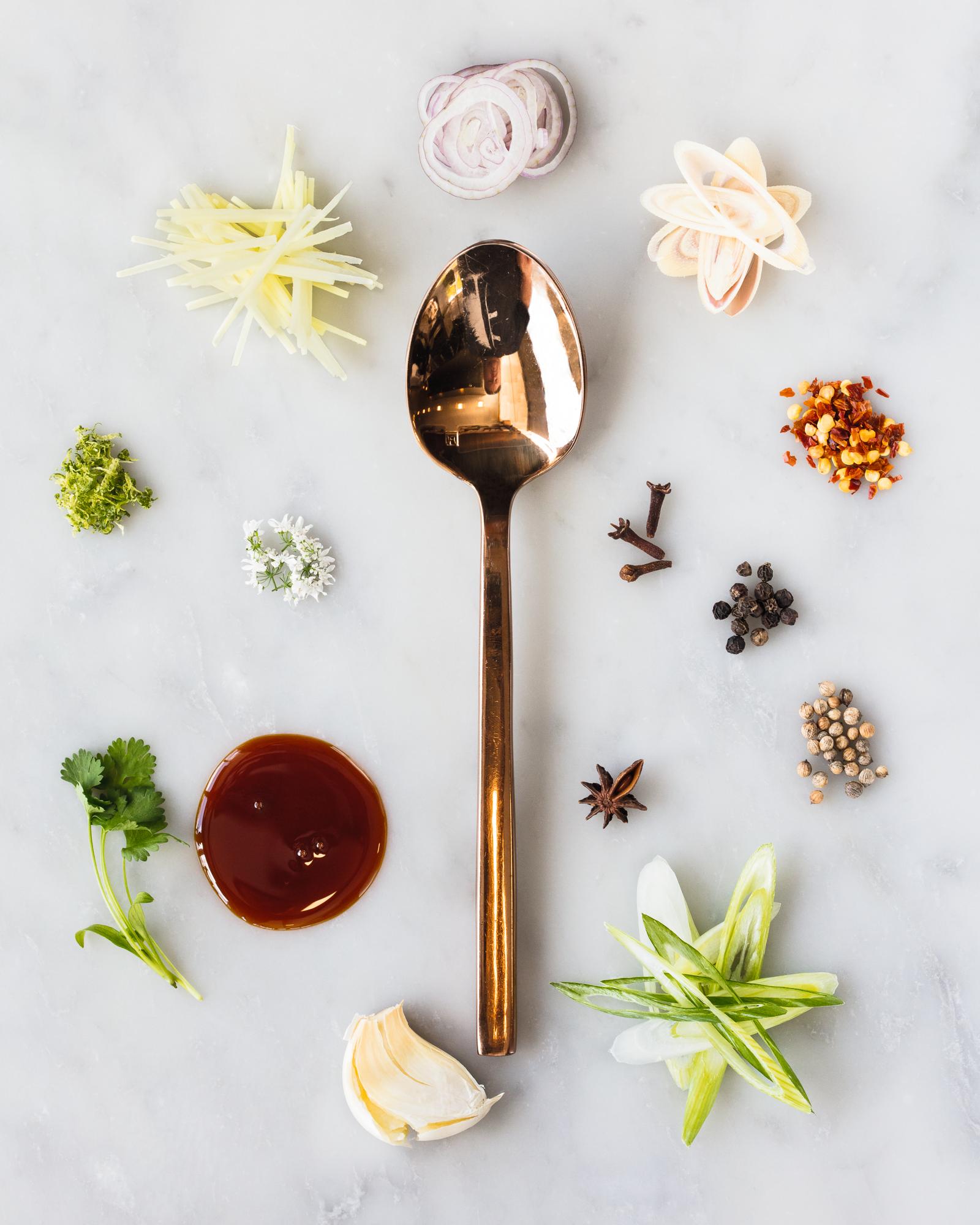 Spoonful portrait of Chef Ehren Ryan titled Modern Melting Pot, featuring lemongrass, ginger, and soy caramel in the first spoon purchased for his restaurant Common Lot.