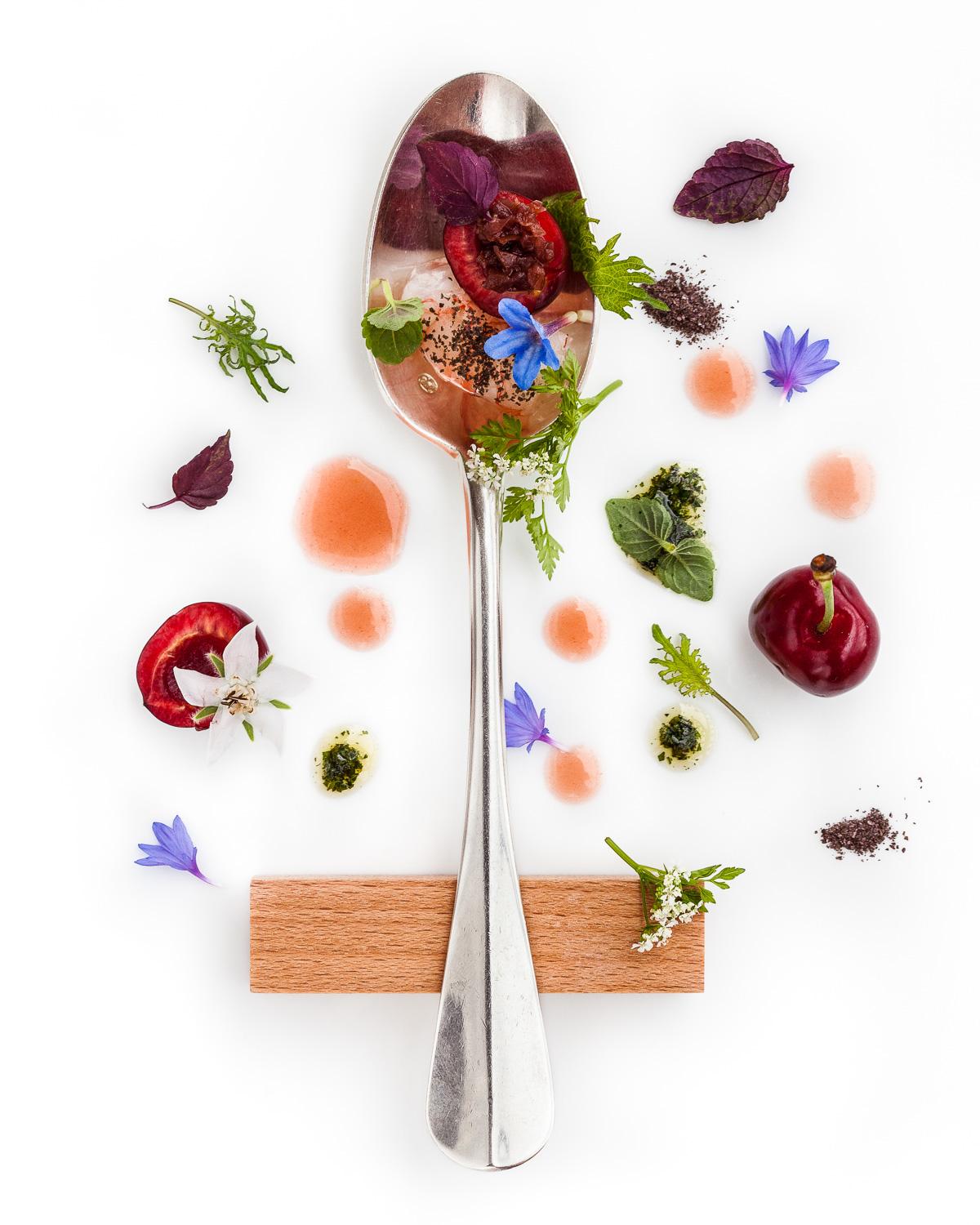 Spoonful portrait of Chef Enrico Crippa titled Cibo Stagionale, featuring prawns from the Ligurian sea, cherries, and orange juice with hand-selected herbs and flowers.