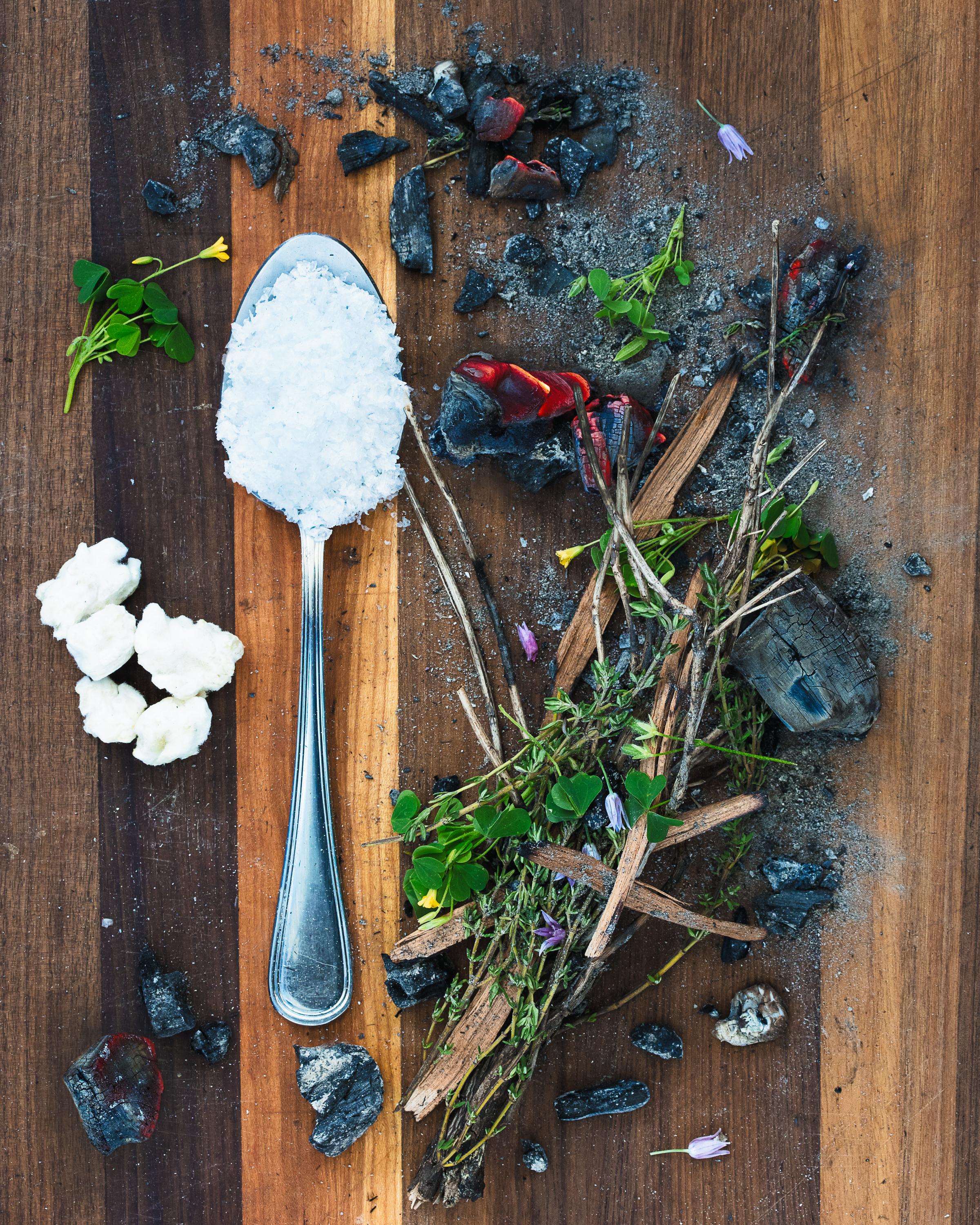 Spoonful portrait of Chef Michael Martello Jr. featuring jasmine rice koji, hardwood charcoal, and ash in an ergonomic $3 corner shop spoon.