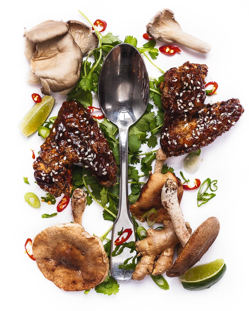 Spoonful portrait of Chef Ryan Hidinger titled Taking Stock in Memories, featuring chicken wings, shiitake and chanterelle mushrooms, and lime.