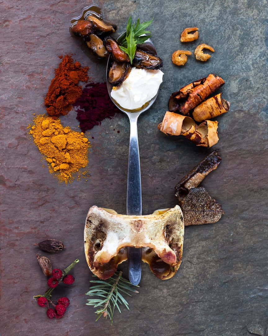 Spoonful portrait of Chef Will Horowitz featuring smoked goat vertebrae, sumac, and kelp in a classic well-weighted teenage spoon.
