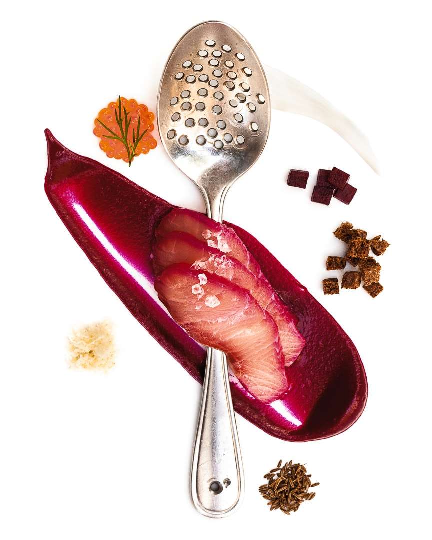 Spoonful portrait of Chef Dave Mawhinney titled Precision and Control, featuring hamachi, beets, and caraway seeds in a personally perforated straining spoon.